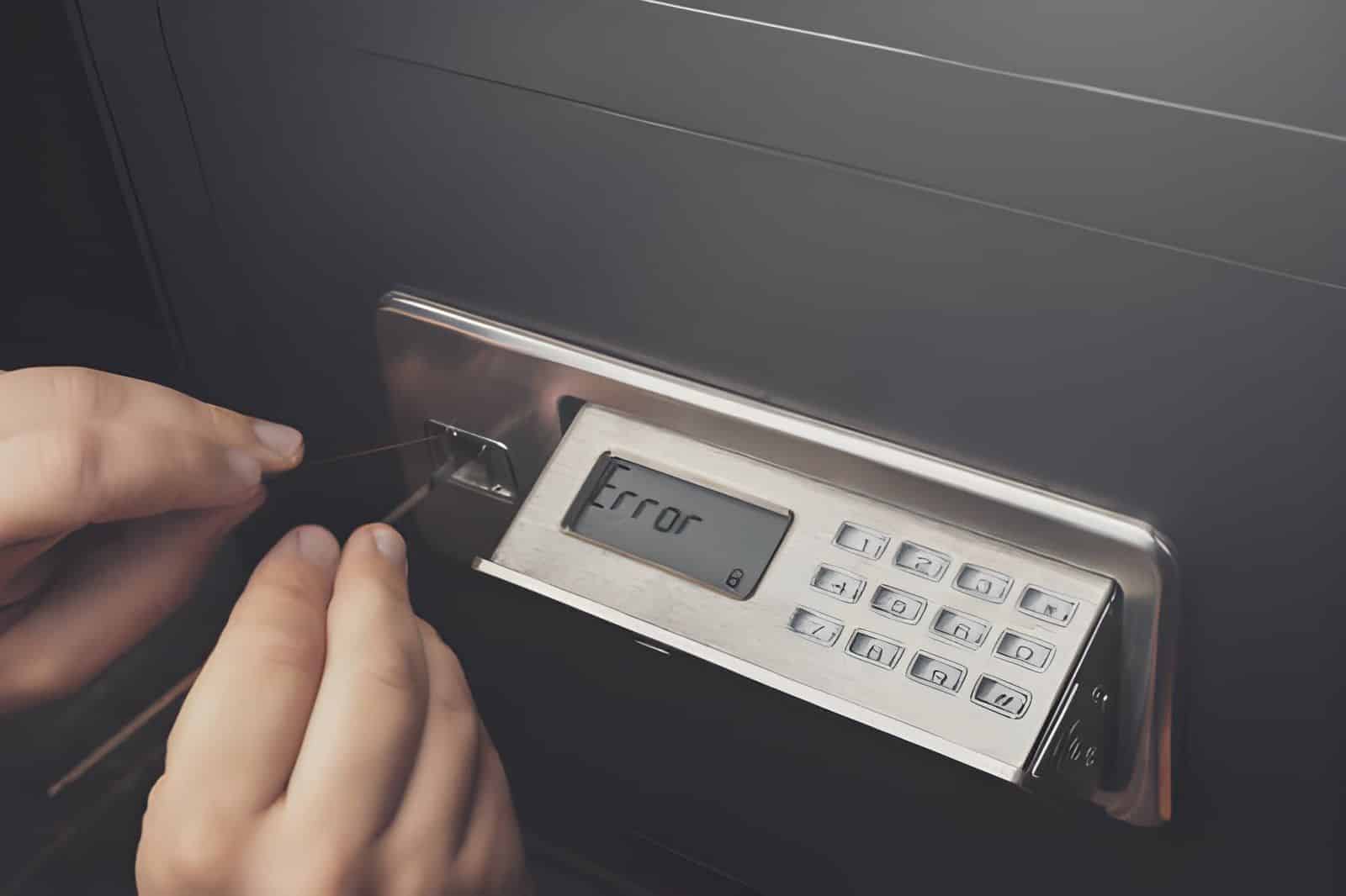 Close-up of Thief's hands attempting to Break Home Money Safe and perform Robbery (1)