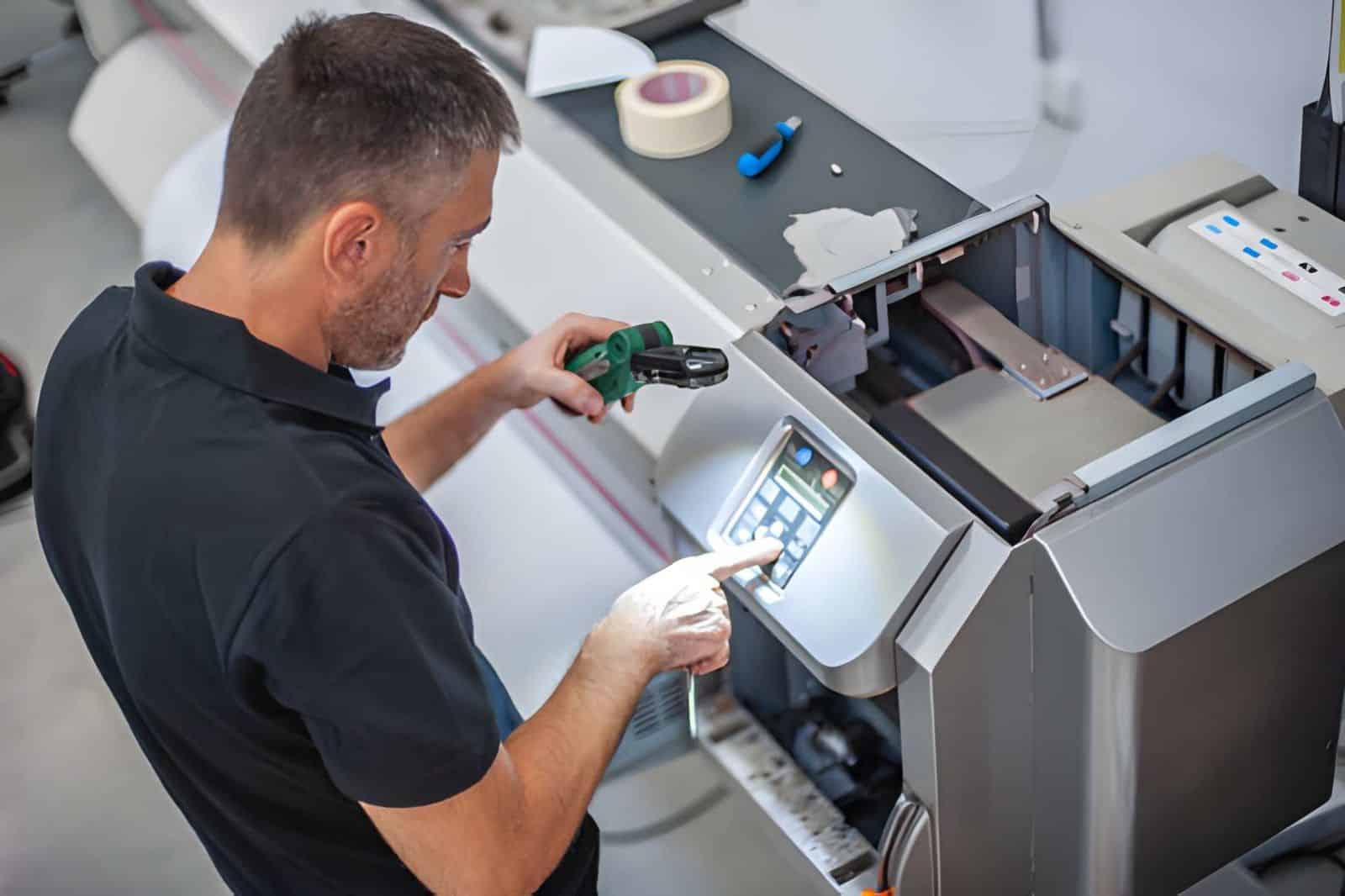 Technician troubleshooting and maintains the machines in the printing house (1)